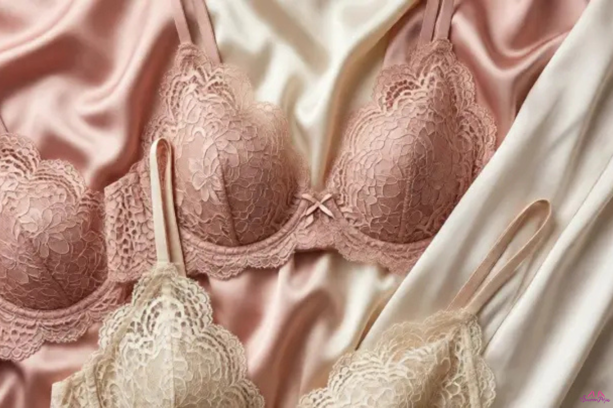 A close-up view of three bras and pieces of lingerie displayed together on a neutral background.